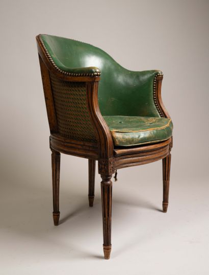 Cane-seated office chair with a molded wooden...