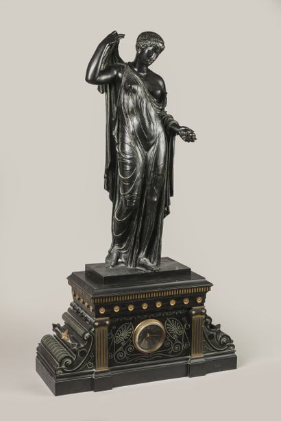 Patinated, gilded and engraved bronze clock...