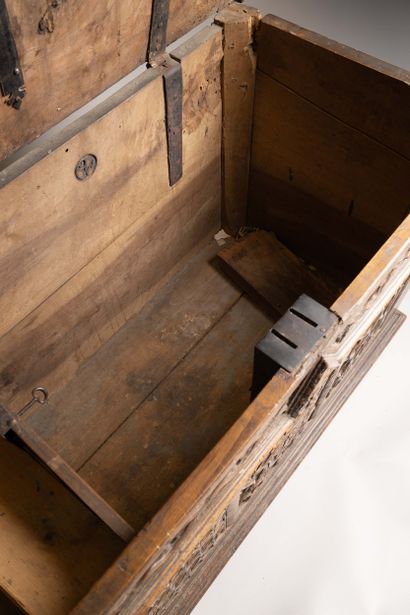 A quadrangular chest made of molded and carved...
