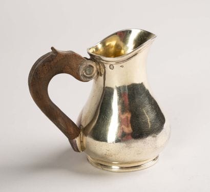 Vermeil pitcher with a smooth body on a small...