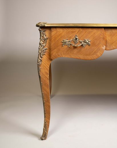 A flat, scalloped-edge desk made of rosewood...