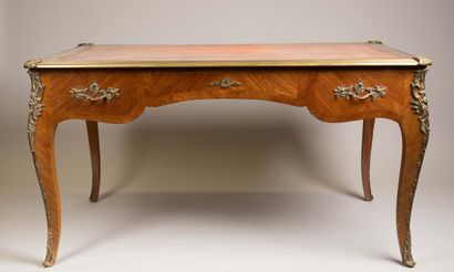 A flat, scalloped-edge desk made of rosewood...