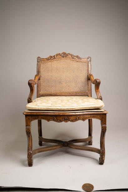 Cane-woven armchair with a queen-style backrest...