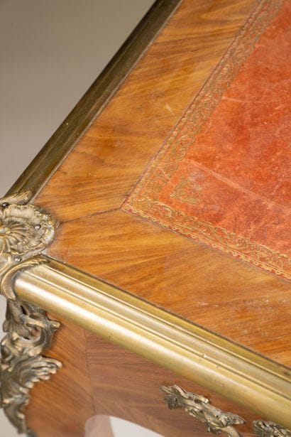 A flat, scalloped-edge desk made of rosewood...