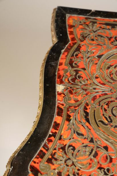 Game table with a broken-shaped top in blackened...
