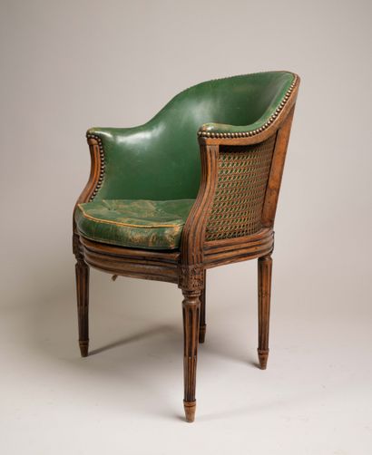 Cane-seated office chair with a molded wooden...