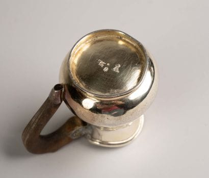 Vermeil pitcher with a smooth body on a small...