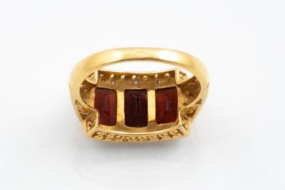A garter-style ring set with three rectangular-cut...