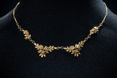 Draped necklace featuring floral garland...