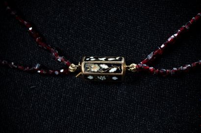 A two-row necklace of small faceted beads...