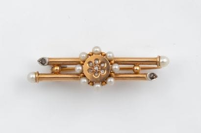 A brooch featuring a daisy motif at its center,...