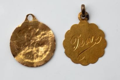 2 dented religious medals made of yellow...