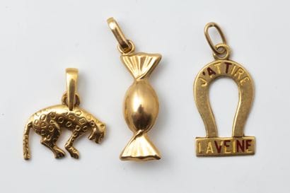 Three pendants or charms depicting a piece...