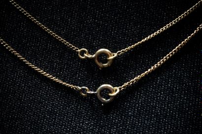 Two yellow gold (750) curb-link chains. Eagle-head...