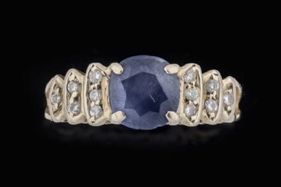 Small ring centered on a sapphire with 6...
