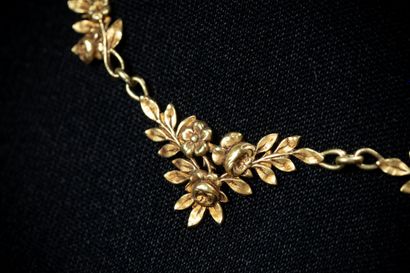 Draped necklace featuring floral garland...