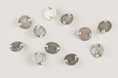 11 silver coins, mounted in knife holders
268...