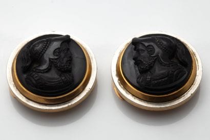 Two large buttons, each adorned with a brown/black...
