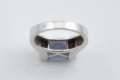 A ring featuring a square, faceted mauve-blue...