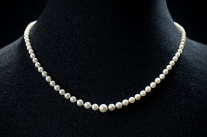 A cascading necklace featuring 99 white cultured...