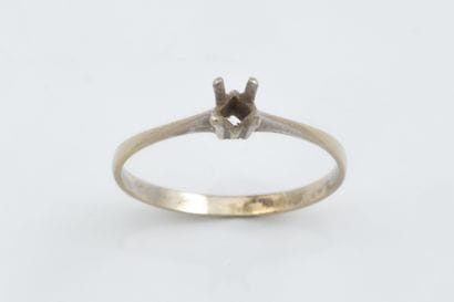 A small solitaire ring set in white gold...