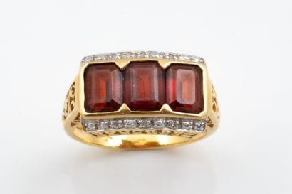A garter-style ring set with three rectangular-cut...
