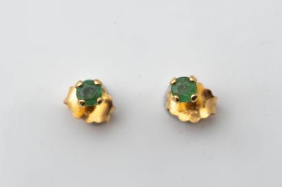 A pair of stud earrings, each set with a...