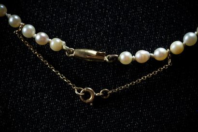 A cascading necklace featuring 124 white...