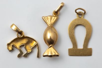 Three pendants or charms depicting a piece...
