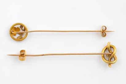 Two yellow gold (750) tie pins. Eagle-head...