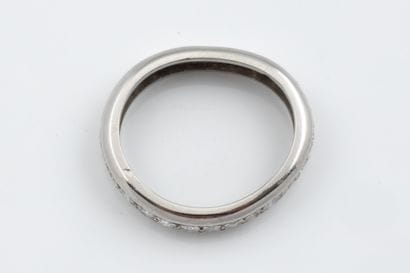 An oval-shaped, irregularly shaped platinum...