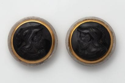Two large buttons, each adorned with a brown/black...