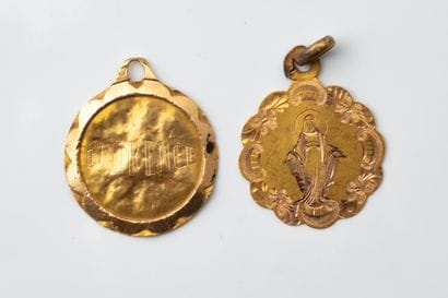 2 dented religious medals made of yellow...