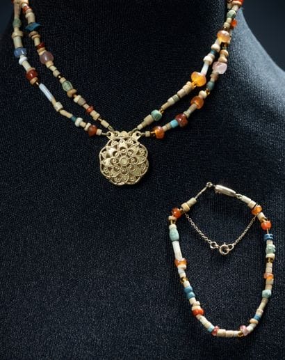Two multicolored stick-style bracelets:
-...
