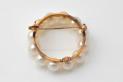 A brooch in the shape of a crown or circle,...