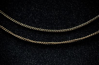 Two yellow gold (750) curb-link chains. Eagle-head...