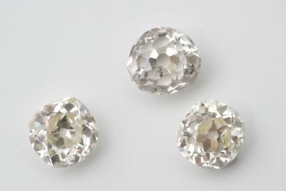 Set of 3 vintage-cut diamonds on paper, one...