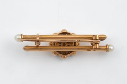 A brooch featuring a daisy motif at its center,...