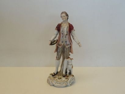 Personnage et son chien en porcelaine polychrome....
