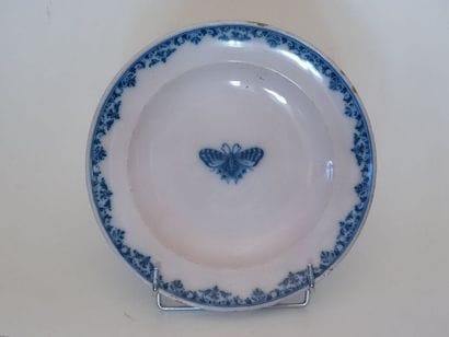 Assiette ronde en faïence à décor en camaïeu...