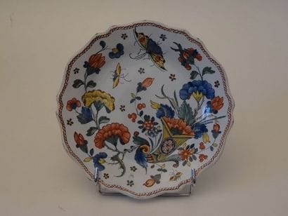 Assiette à contours lobés en faïence polychrome....