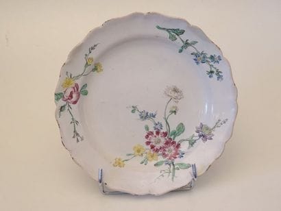 Assiette en faïence à contour orné d'un jeté...