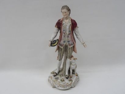 Personnage et son chien en porcelaine polychrome....