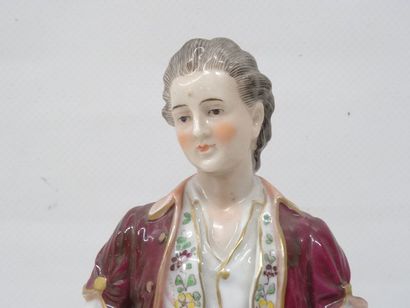 Personnage et son chien en porcelaine polychrome....