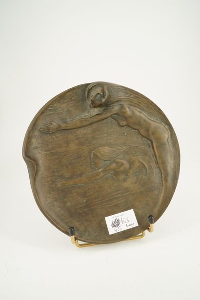 Coupe plate en bronze patiné à décor de deux...