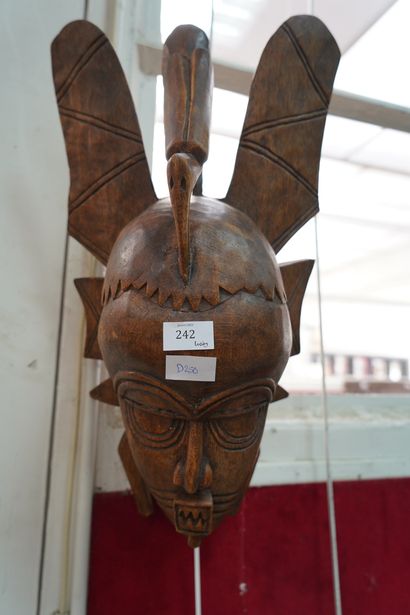 Masque africain en bois sculpté surmonté...