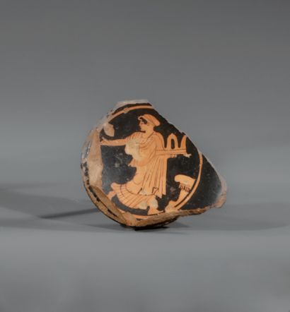 FRAGMENT OF A STEMLESS BOWL WITH RED FIGURES
The...