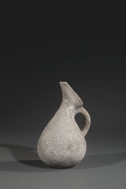 REVERSE SPOUT JUG
Pyriform body, neck decorated...