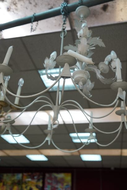 Un lustre en métal laqué beige à huit lumières....