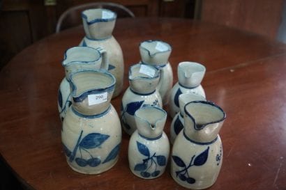 Suite de neuf pichets en grès à décor émaillé...